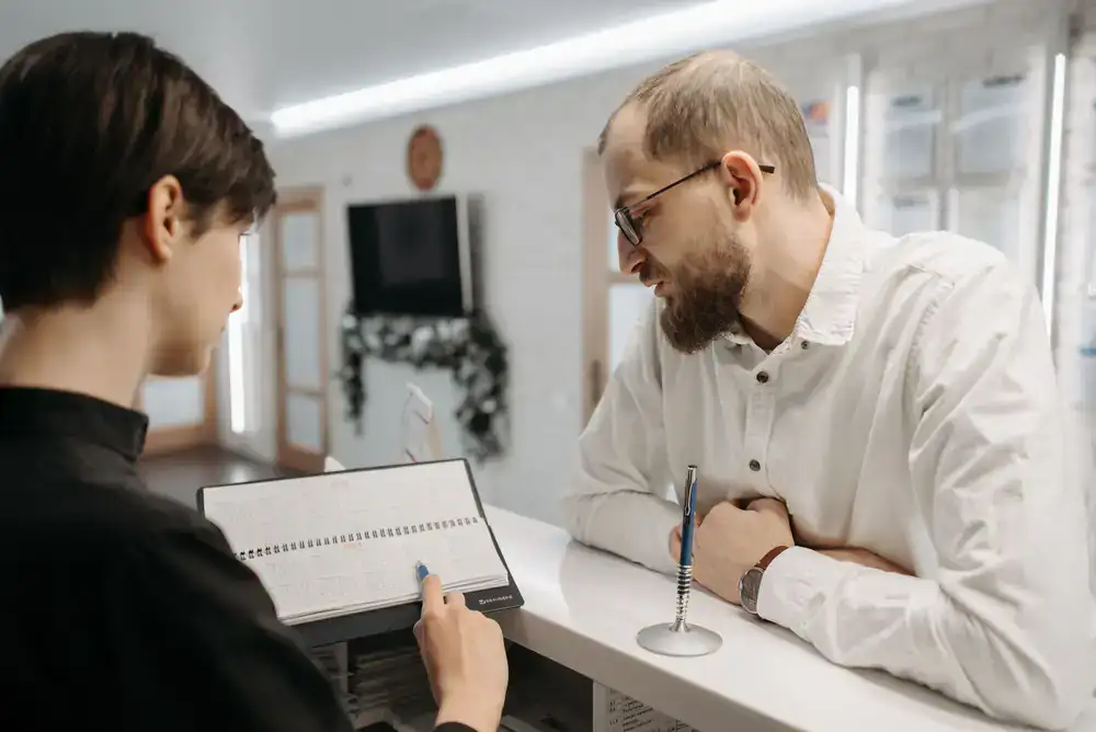 Client booking an appointment at the studio front desk