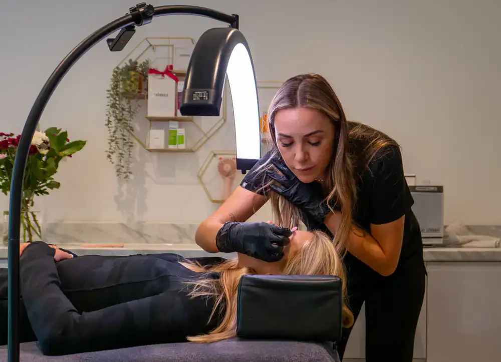 Client receiving a precise brow treatment at the studio